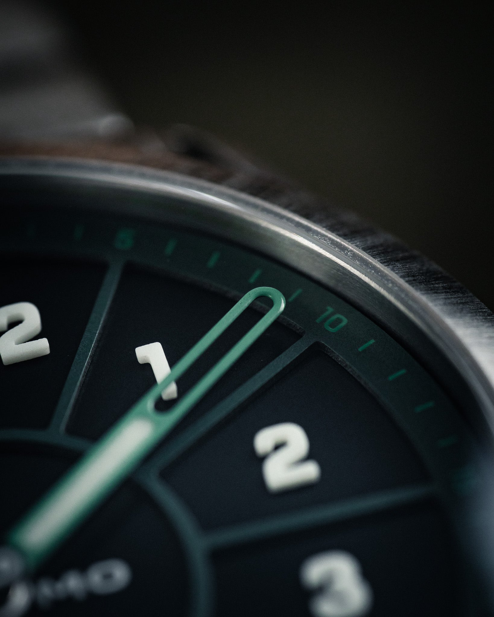 Close-up of SLOMO Watches Glance automatic watch on featuring a green dial. Showcasing the clear-view skeletonized hands.